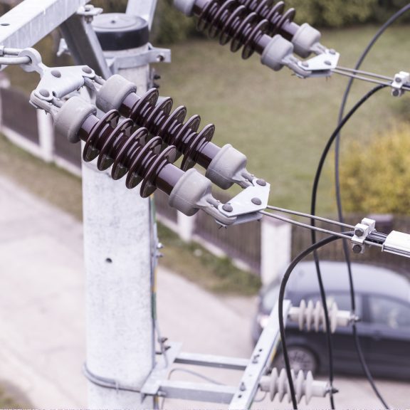 Drone conducting professional inspection of power lines to support safe and efficient EV charging infrastructure