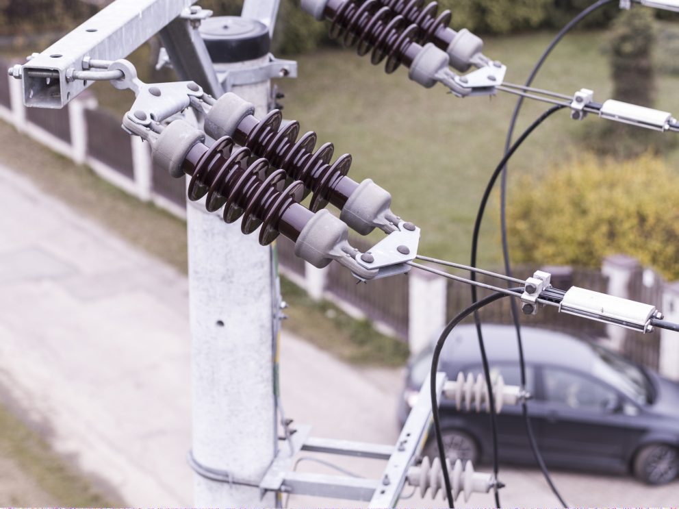 Drone conducting professional inspection of power lines to support safe and efficient EV charging infrastructure